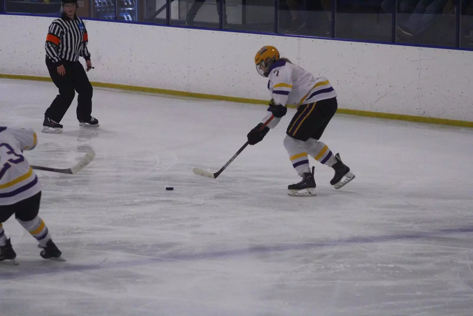 Marie Reimer skating the puck down the ice towards the net