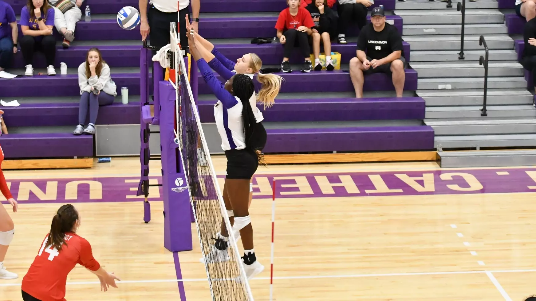 Maggie Rosen and Madison Fagan blocking at the net