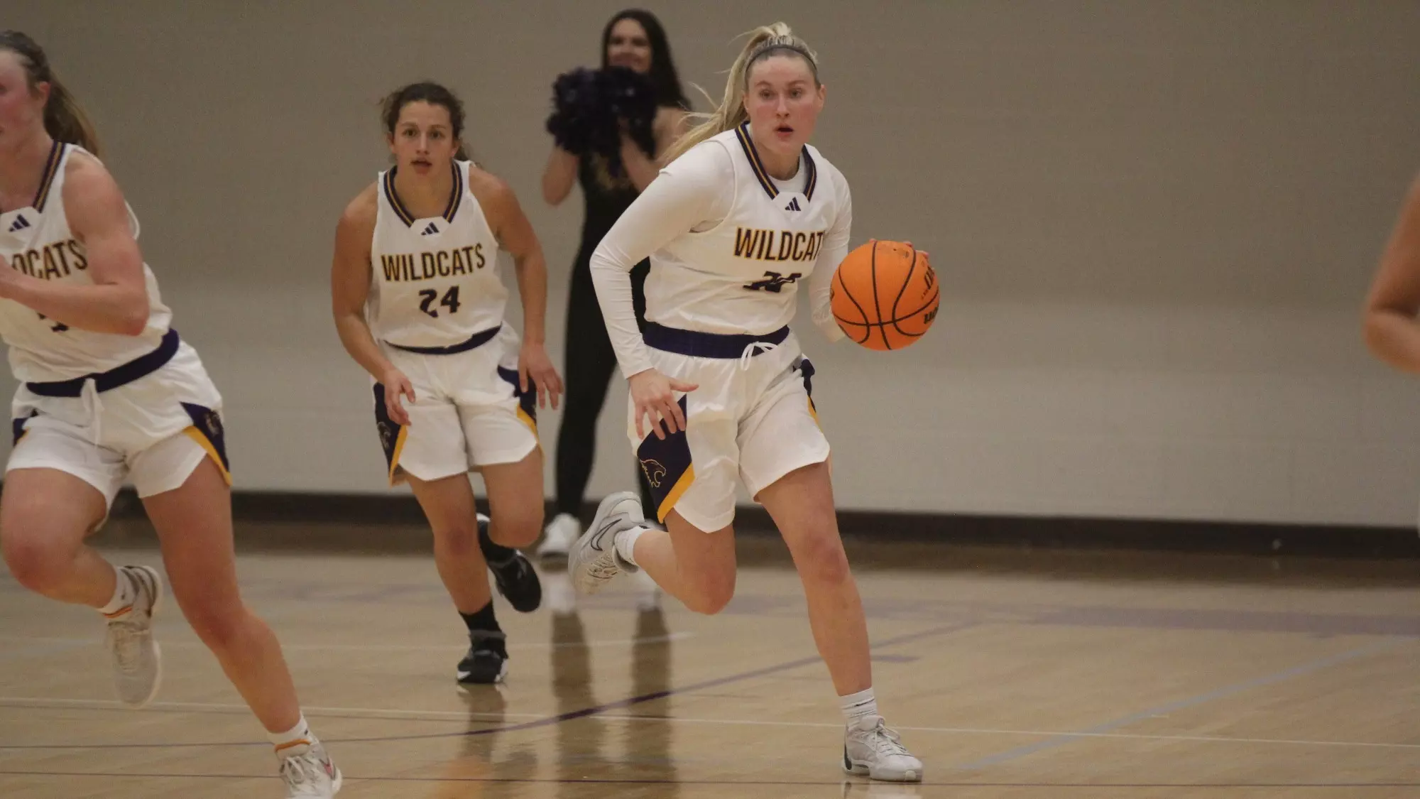 Maddie Young dribbling down the court