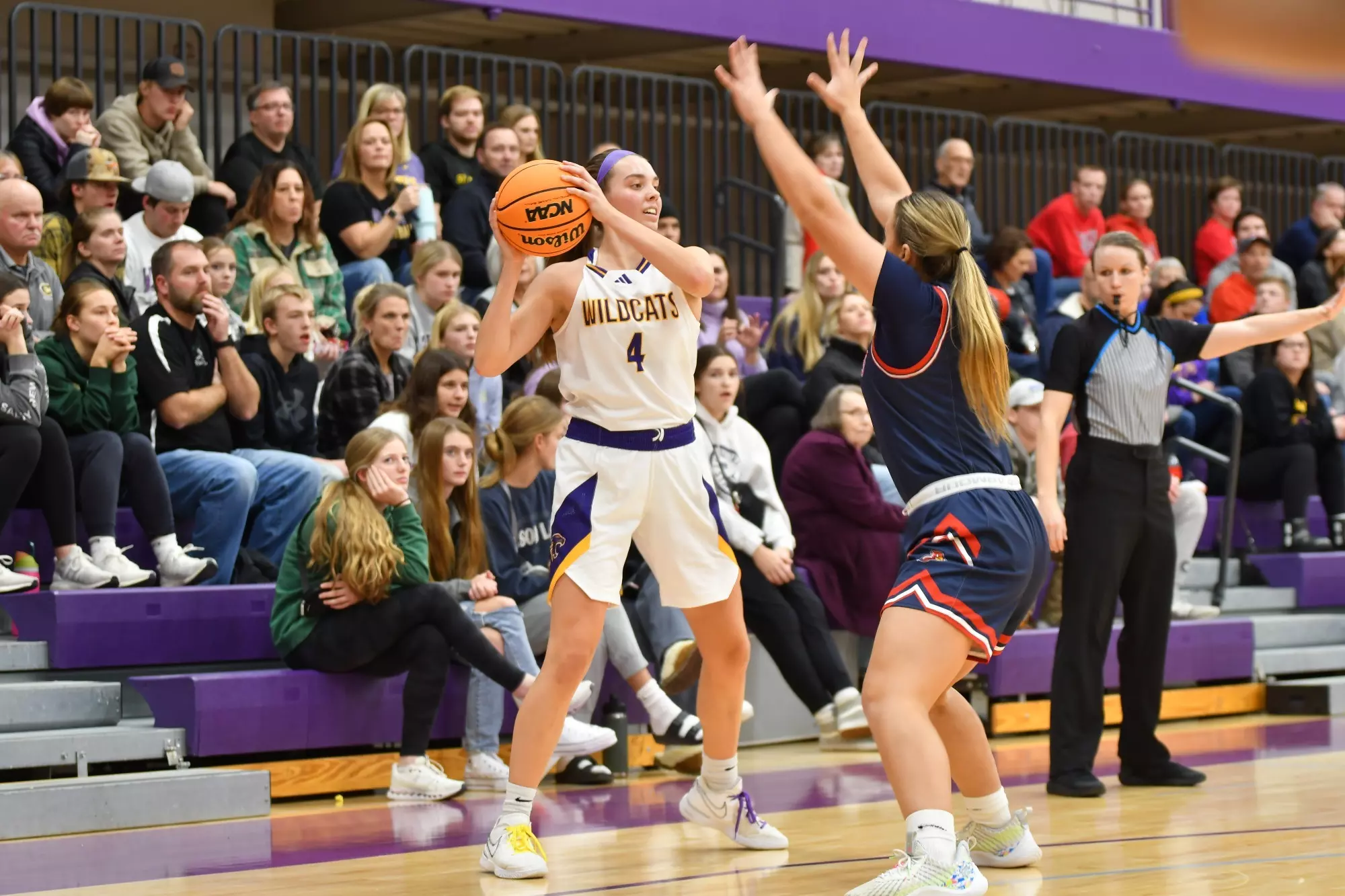 Greta Schimnowski holding basketball with saint mary