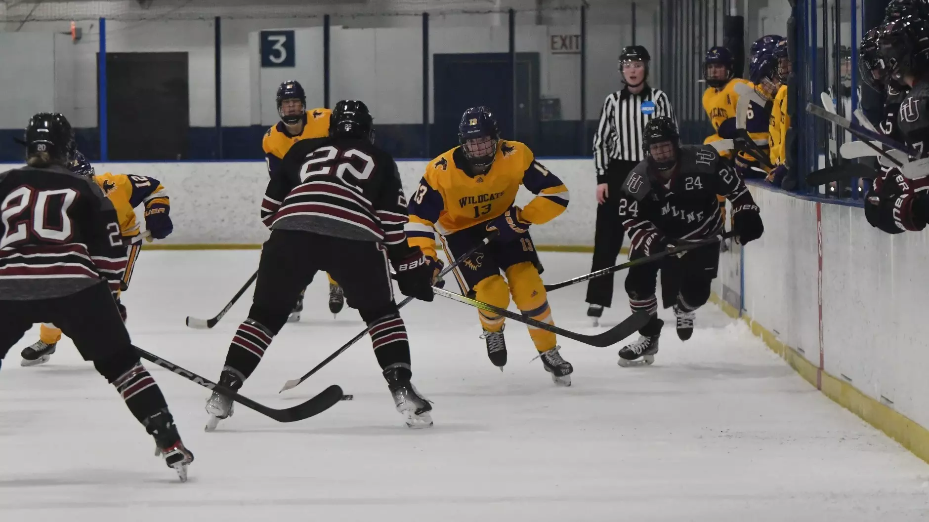 Abby Pirkl skating down the ice with the puck as hamline players are defending