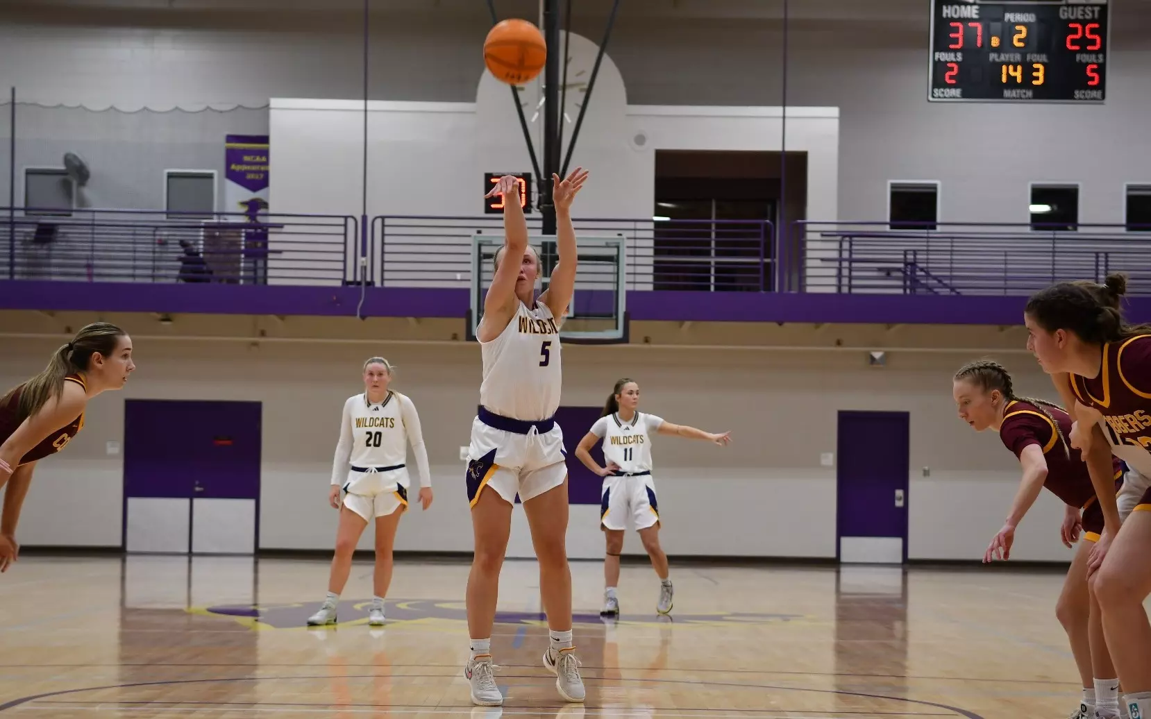 Hattie Fox at the free throw line shooting basketball with St. Kate