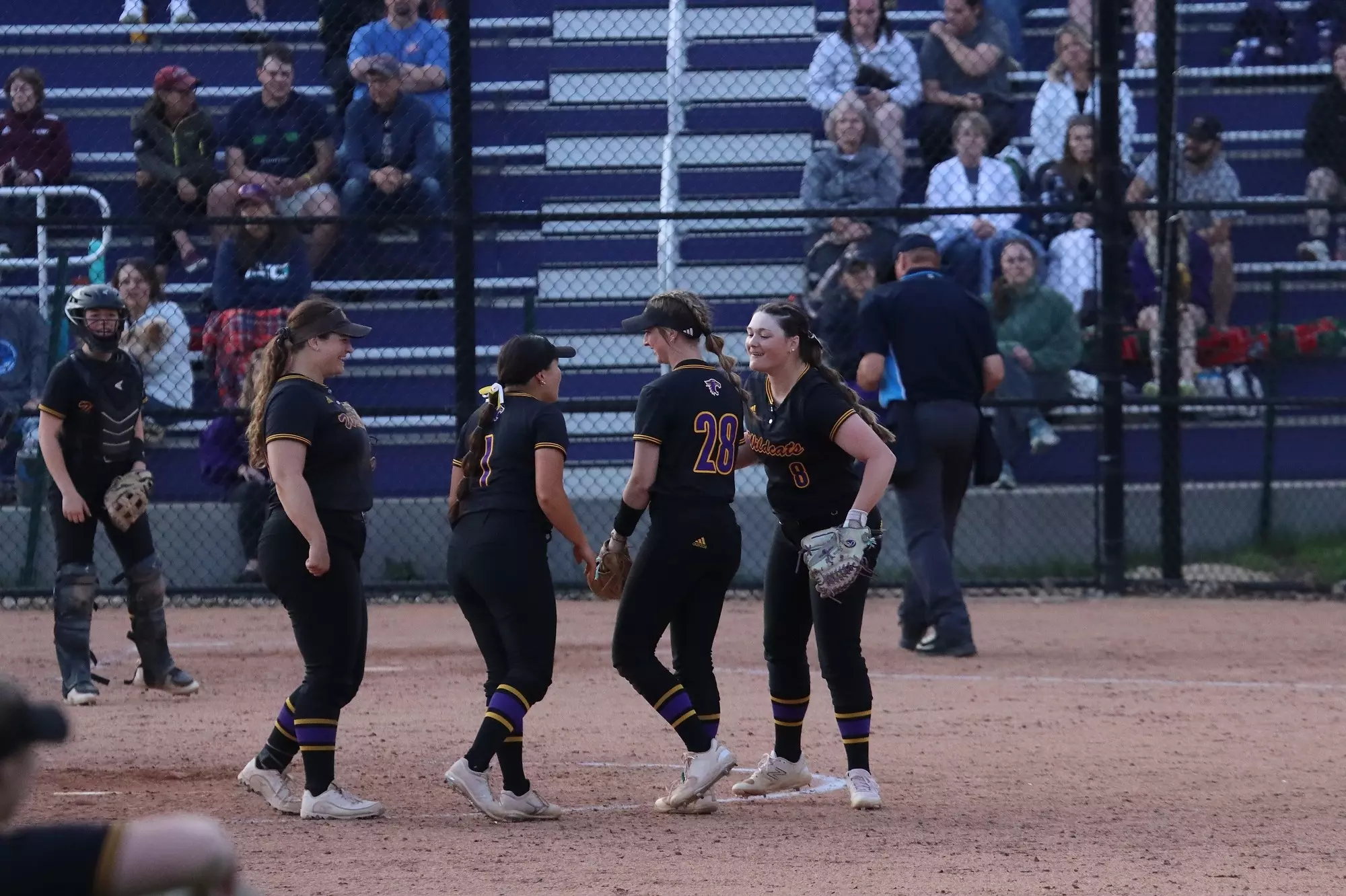 Softball team celebrating final win of the season at home