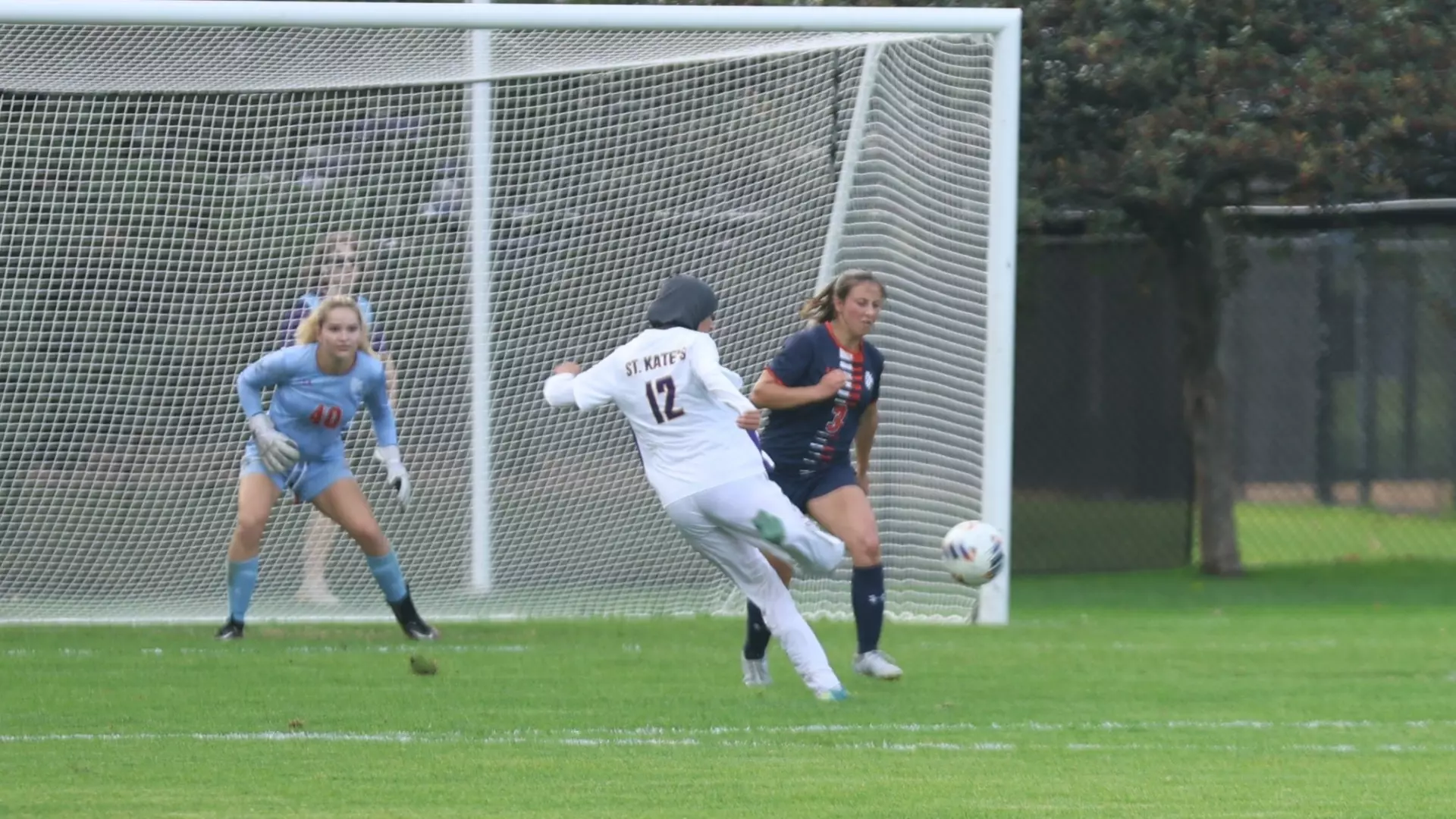 Ayah Makled shooting on macalester goalie at home