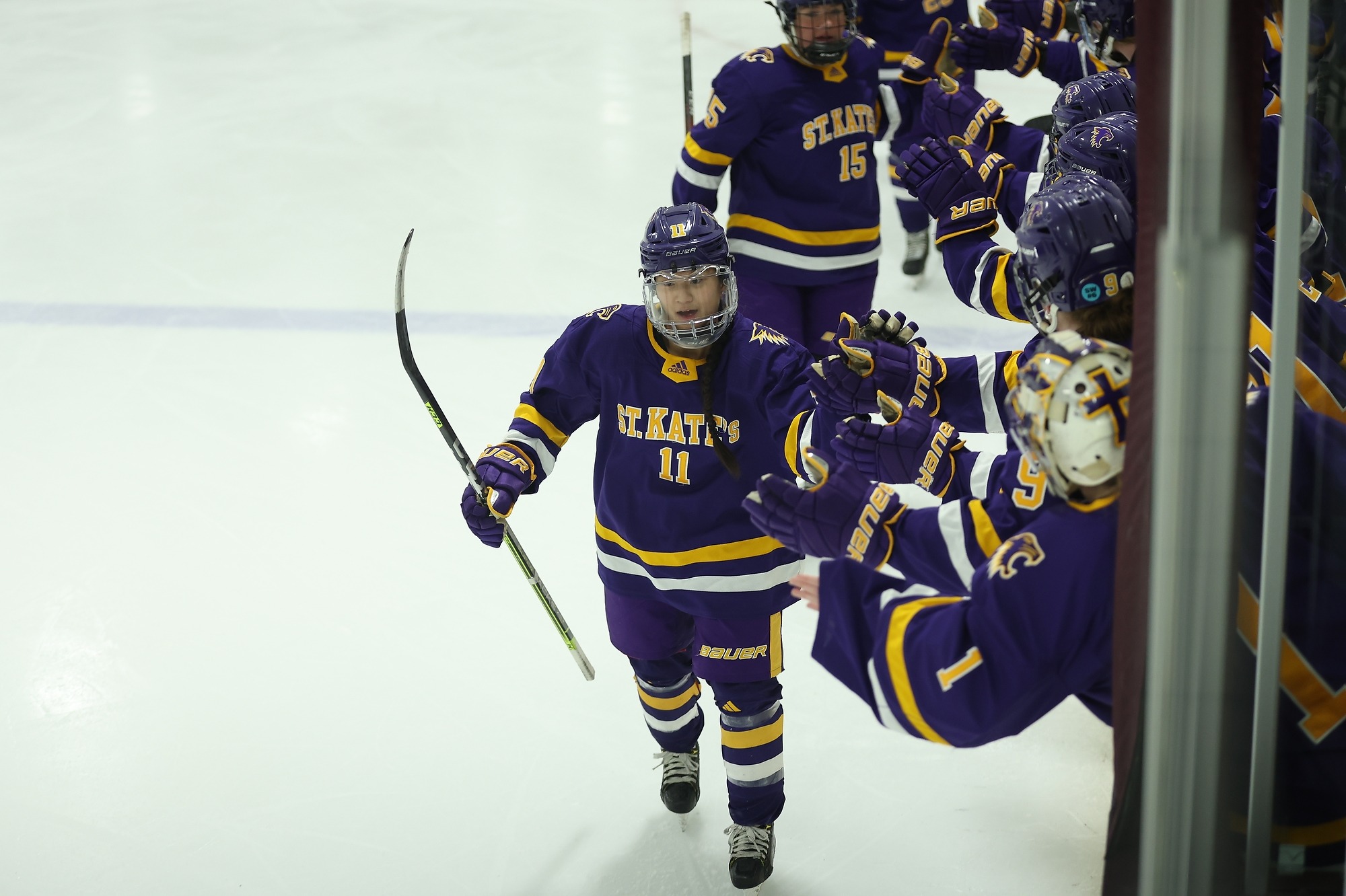 Sarah Wangen celebrating goal by clapping hands with team