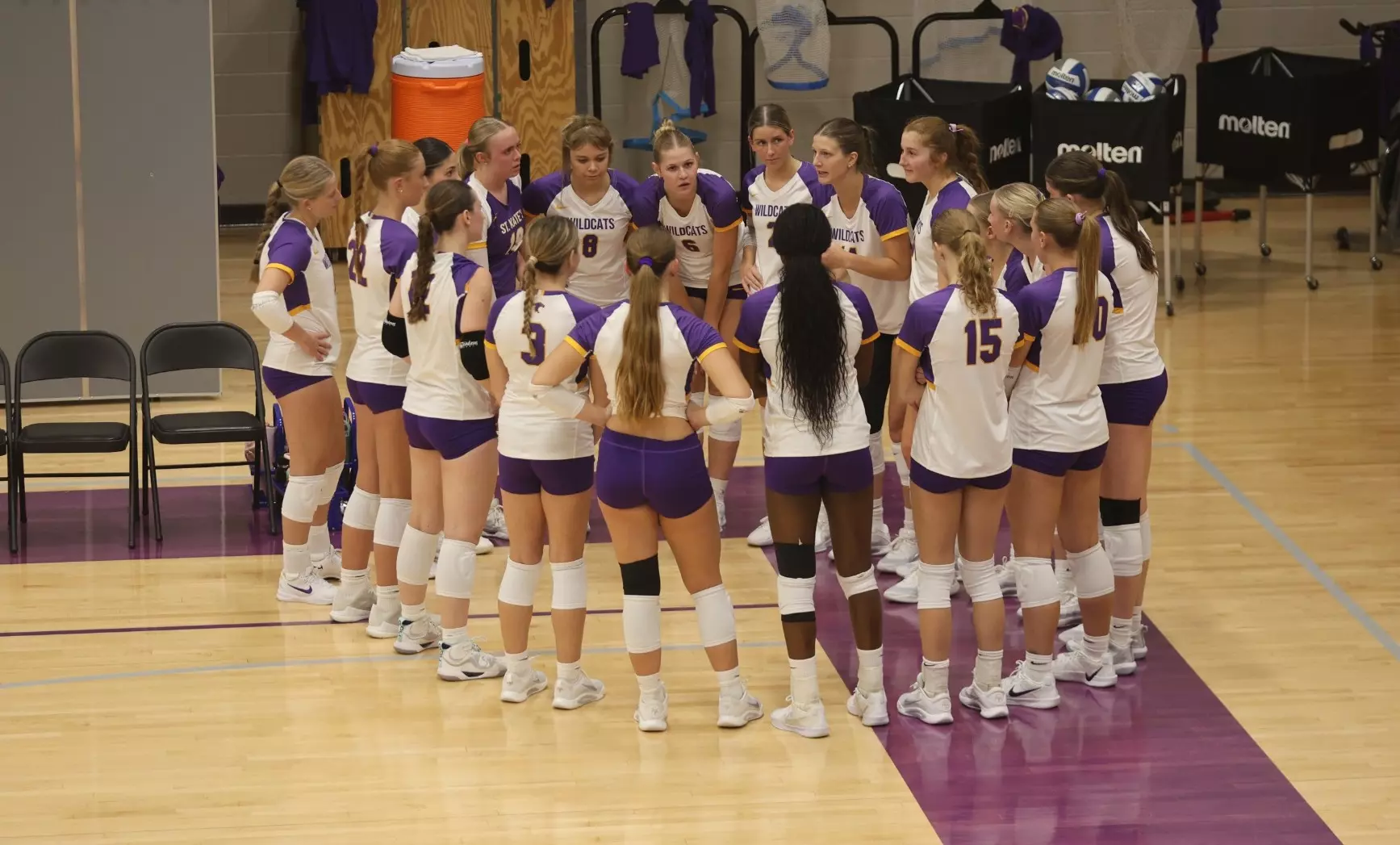 Volleyball team huddle at Butler Center gym
